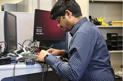 Dr. Prasanth Yanambaka working with computer equipment.