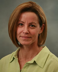 Headshot of Leslie Francke wearing a light green collared shirt