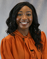 Headshot of Obianuju Madu wearing an orange top.