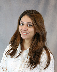 Headshot for Breeha Saeed wearing a white blouse.