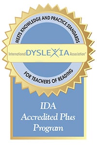 Accreditation badge from International Dyslexia Association. Text reads: Meets knowledge and practice standards for teachers of reading. IDA Accredited Plus Program