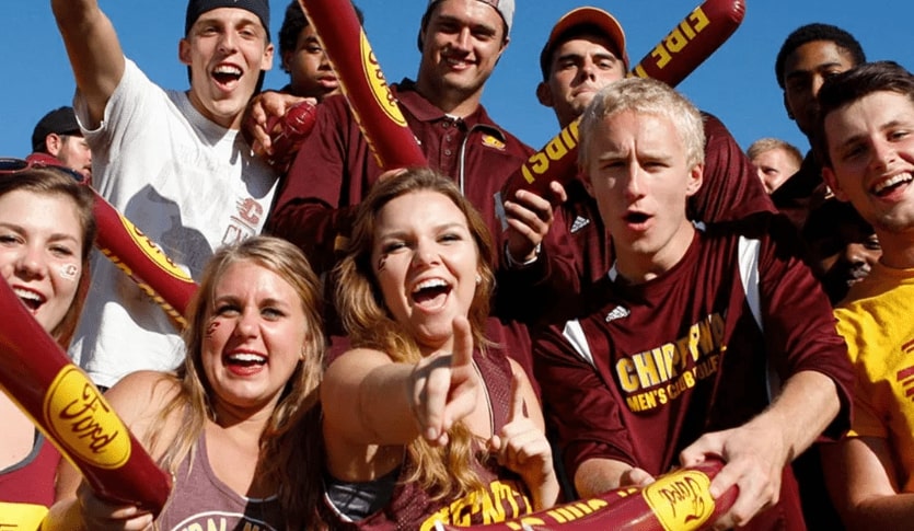 A group of CMU Students are fired up for a football game and posing for the camera.