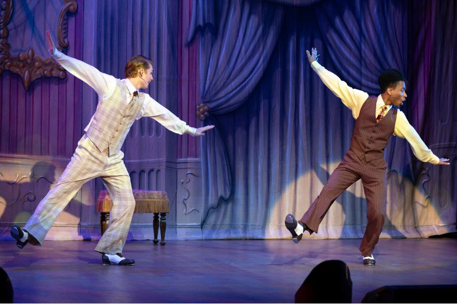 The Drowsy Chaperone Dance Photos Two men tap dancing on stage in spotlight.