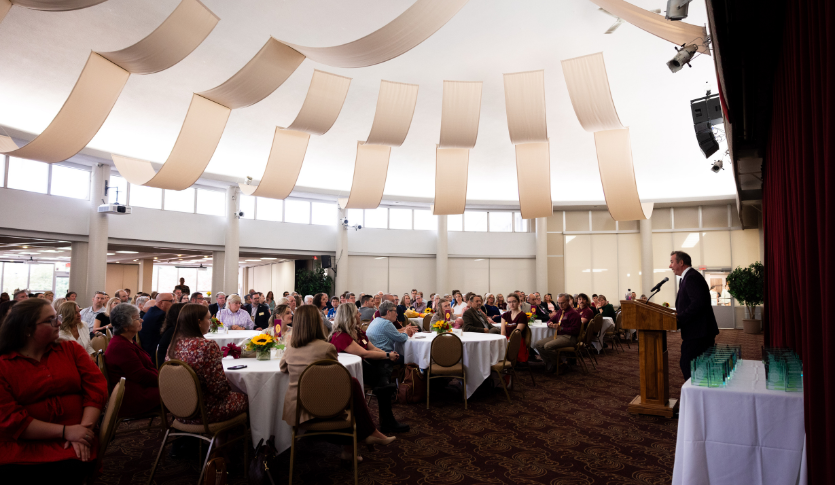 a group of people sitting at tables in a room