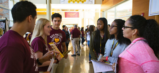 CMU and You Day prospective students visiting with CMU staff