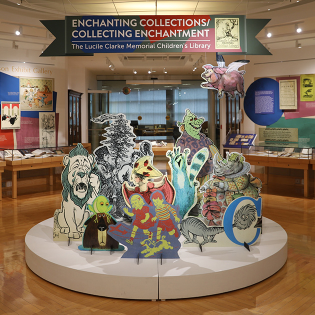 Entrance of the Enchanting Collections exhibit with several large cut-out characters from children's books