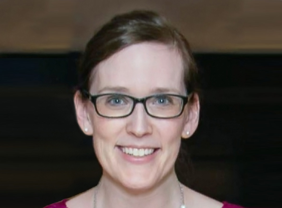 Closeup headshot of Executive Director Jewish History Museum of Michigan Catherine Cangany on a dark background.