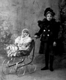 Photo of Gould with a doll and baby buggy