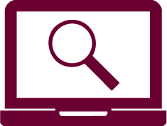 Laptop open with magnifying glass on screen.