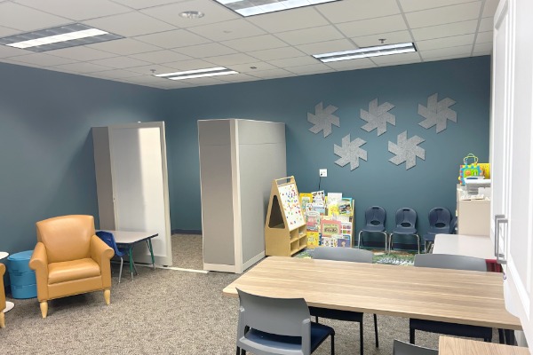 Family study room features work tables, childrens books, childrens reading area, toys, nursing privacy booth, and desk with computer.