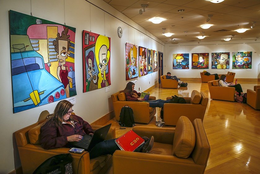 Students studying individually in comfortable furniture located in the Baber Room, Park Library.