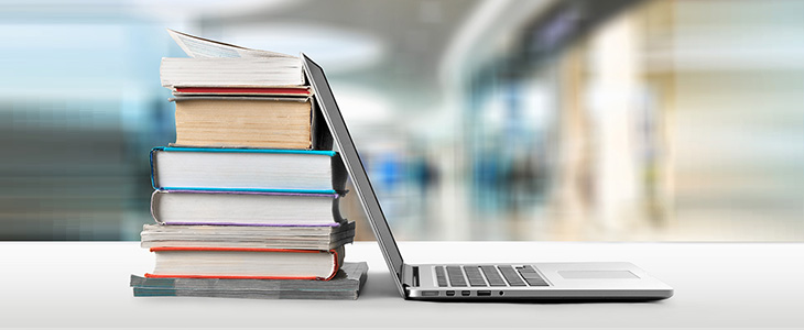 Showing image of textbooks and laptop for Research Consultations.