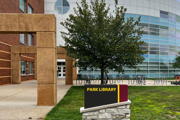 Still image of the Park Library south entrance featuring the Park Library wayfinding sign