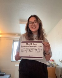 Lindsey Nguyen holding a sign that says 