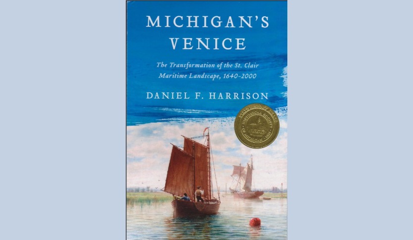 Book cover: Michigan’s Venice, the Transformation of the St. Clair Maritime Landscape, 1640 – 2000 Blue sky with wooden boats with red sails in calm waters.