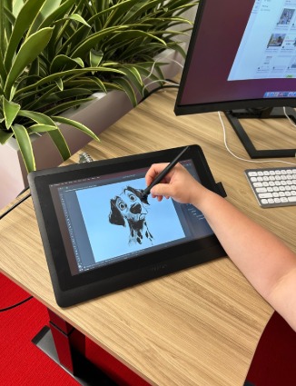 Student drawing a Dalmatian on a Wacom tablet