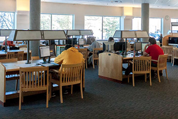 Students working on computers at tables in the 1 North Study Room