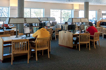 Students working on computers at tables in the 1 North Study Room