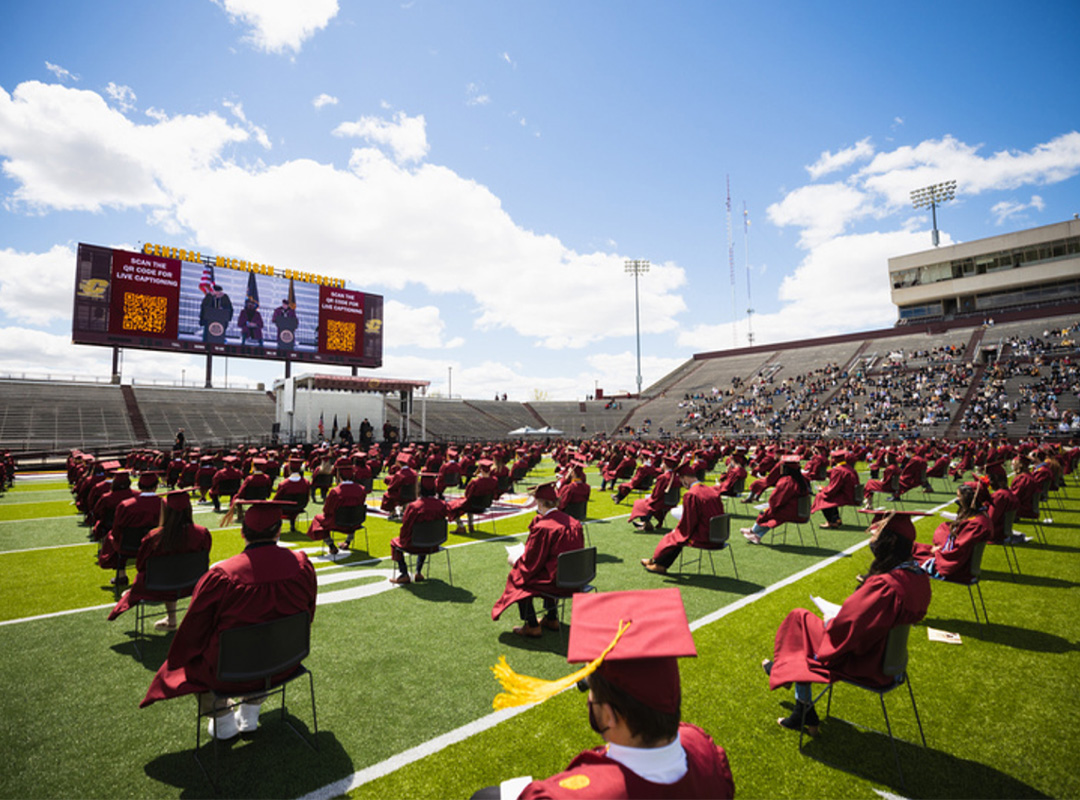 CMU Graduates at the football field for graduation during the pandemic.