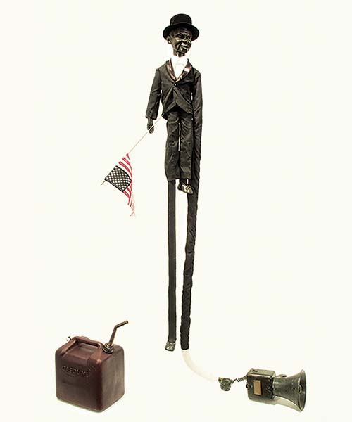 Incendiary Devices, cast and fabricated bronze, 1976 Juro Charlie McCarthy ventriloquist doll, American flag, gas can, and megaphone