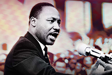 Martin Luther King Jr. speaking at a podium to an audience.