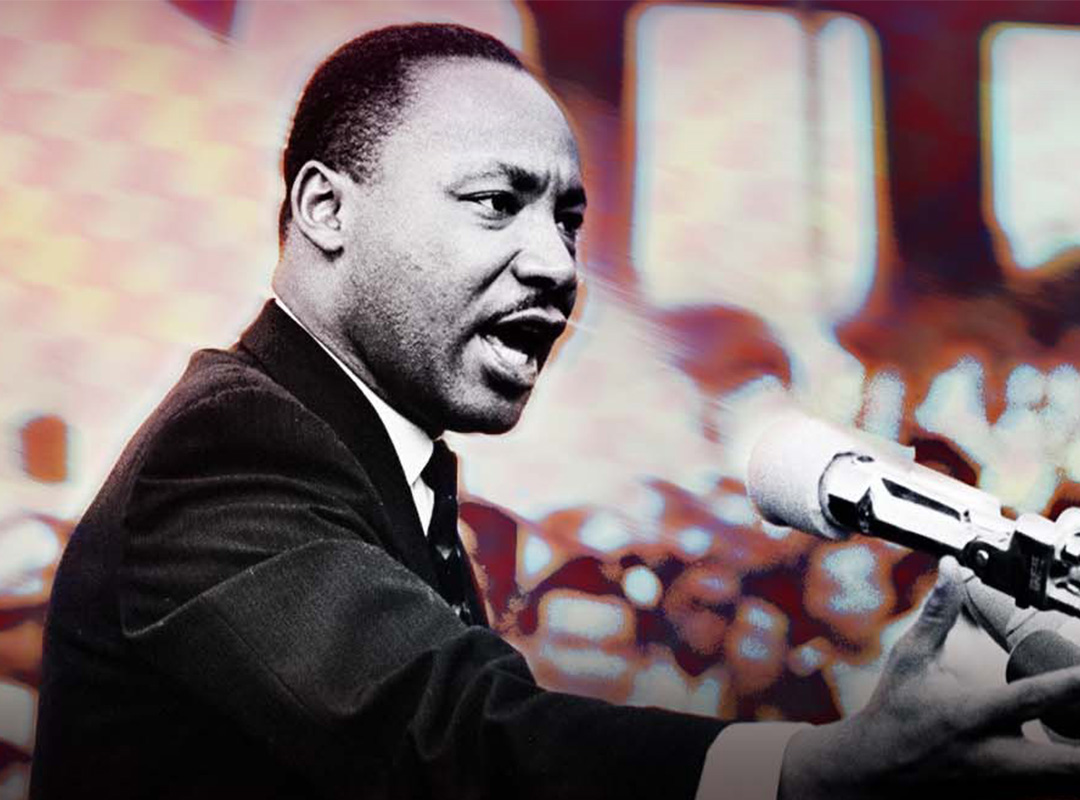 Matin Luther King Jr. speaking at a podium to an audience.