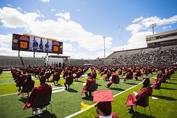 Graduates outside at an outdoor graduation during the pandemic.