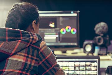 Student working at a computer using Adobe Creative Suite Software.