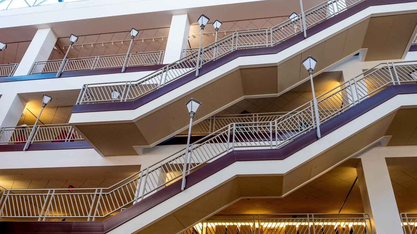 Library staircase viewed from below, looking up in the atrium.