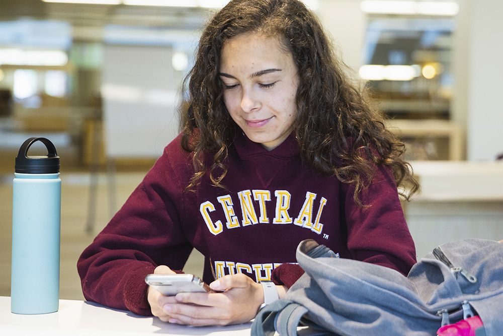 A student checking their cell phone.