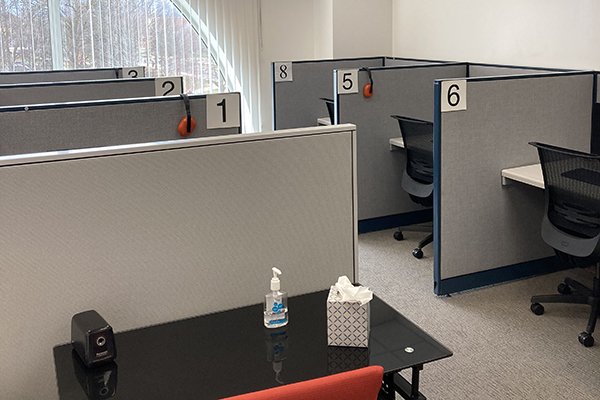 Empty computer testing station desks with numbers