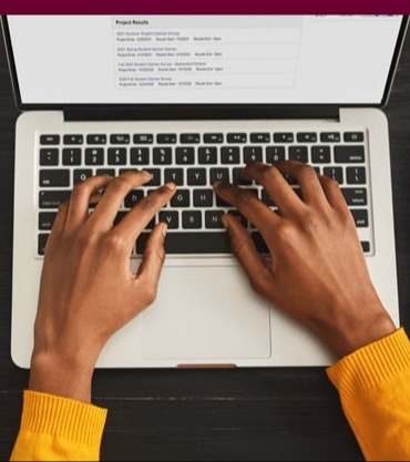 Hands typing on a laptop