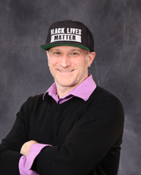 jared halter portrait showing head and shoulders, smiling, on a gray background