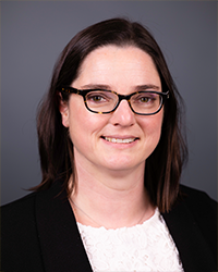 A head and shoulders portrait of Wendy Robertson on a gray background.