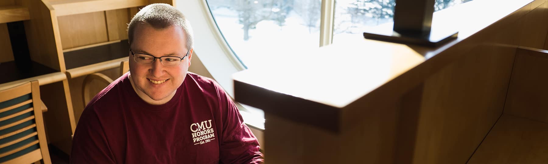 An honors student studies in the library on campus.