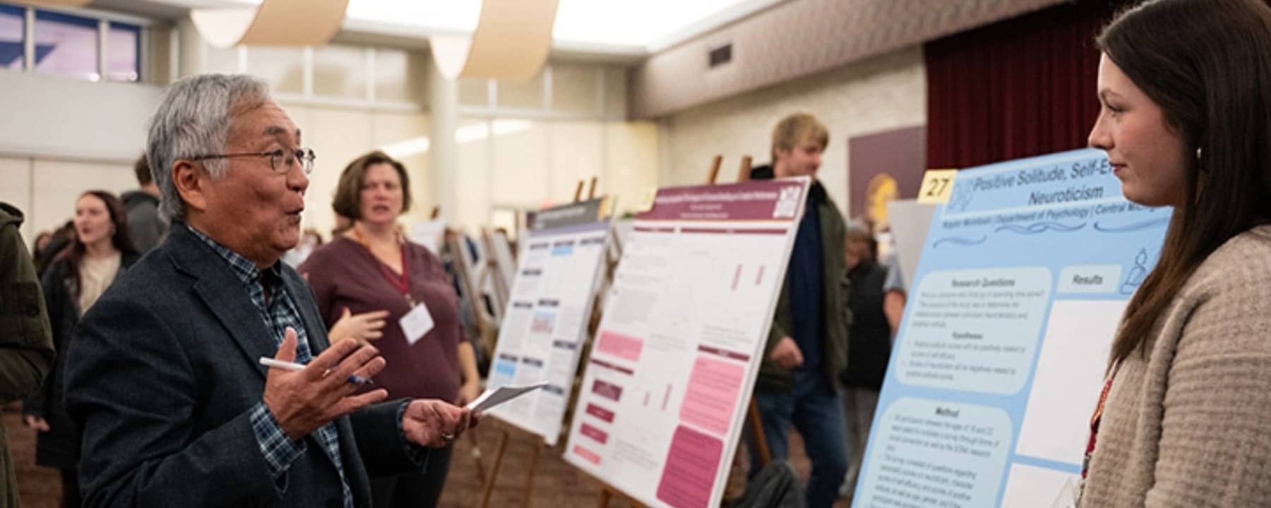 a group of people standing in front of a poster