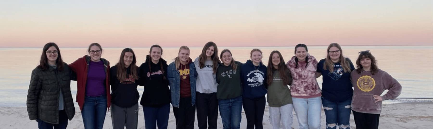 A group of students takes a break from community service to pose for a picture.