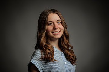 Young woman with long brown hair smiling