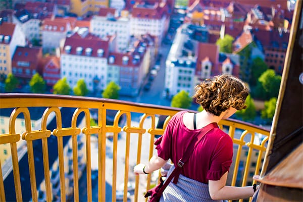 A student walks down stairs in Denmark.