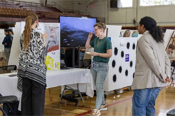Student presenting research at SCREE event.