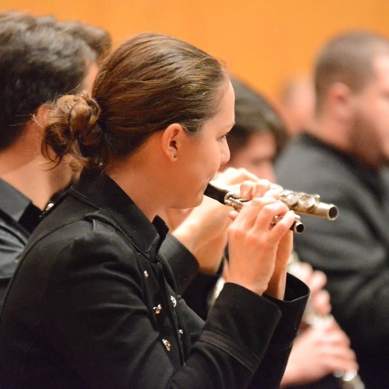 Hope Spaw wears a black uniform while playing the piccolo.