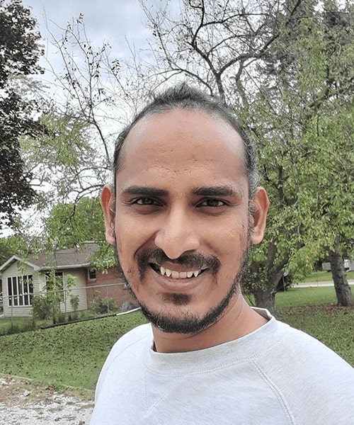 Naveen Kumar Reddy Patil poses for a photo outside after utilizing software to speed up the writing of admission letters.