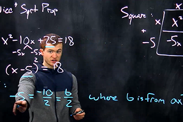 Isaac Cinzori in a hoodie completing a math problem on a transparent board.