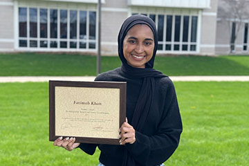 A woman holding an award.