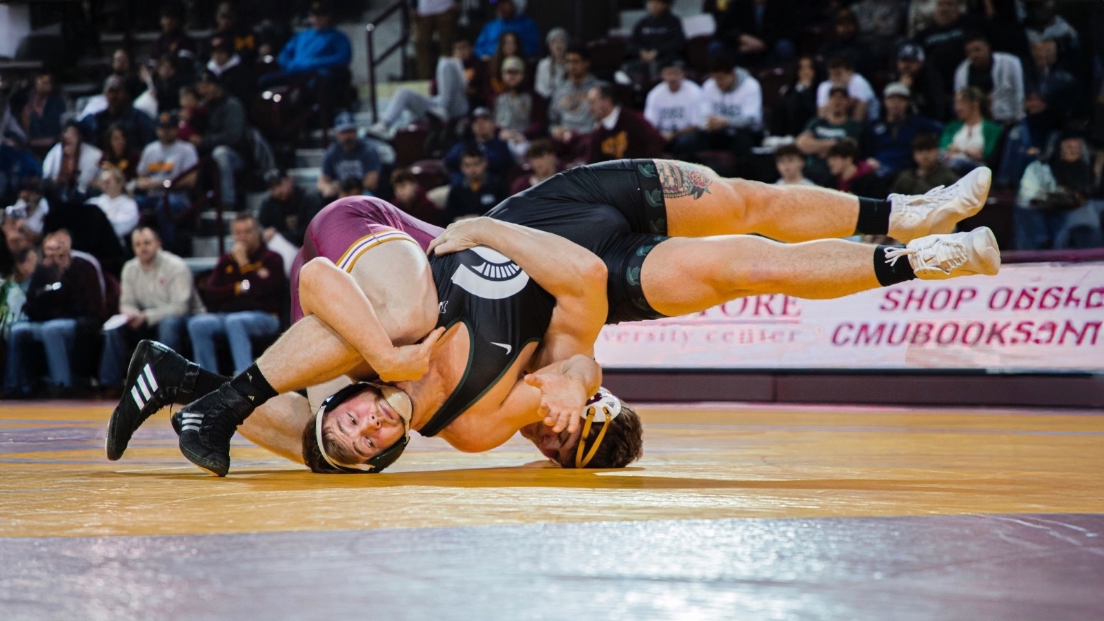 A man wrestling another man in a wrestling match.
