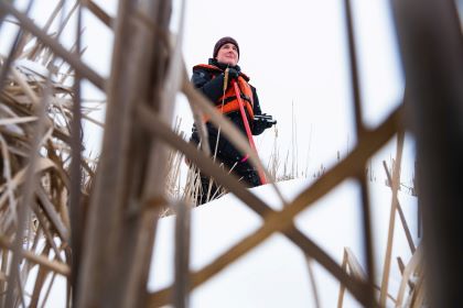 CMU faculty in outdoor winter gear conducting fieldwork in a wetland