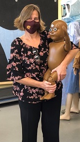 Professor Susanne Wroblewski holding a baby manikin named Lumi.