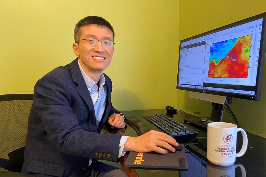 Picture of Tao Zheng at his computer