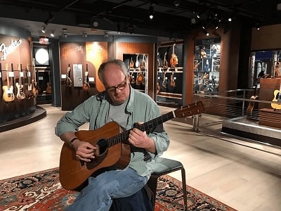 Picture of Will Anderson with guitars