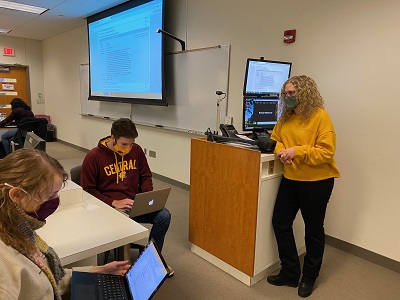 Faculty member Natalie Douglas speaking with students in a classroom